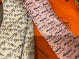 two ties that are laying next to each other on a table