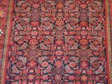 an oriental rug with a red and blue design on it