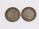 two silver coins with the image of a man and a woman on them