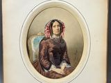 an old picture of a woman in a brown dress sitting on a chair