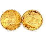 two pieces of gold coins are shown on a white surface