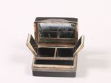 a small metal box with a mirror inside of it