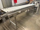 an image of a conveyor belt in a factory with a conveyor belt in the foreground