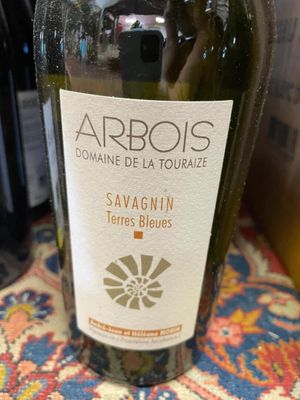 a bottle of wine sitting on a table next to a bottle of wine