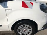 a small white car with a red stripe on the side of it