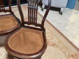 two chairs that are sitting on a rug in a room