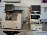 two computers and a printer sitting on a desk