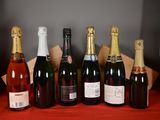 several bottles of wine are lined up on a red table