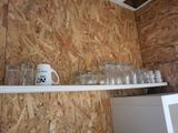 a shelf with cups and mugs on it in a room