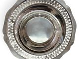 a silver plate with a circular design on it