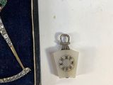 a small clock that is in a box with a key