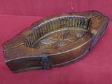 an old wooden instrument on a red cloth on a red surface