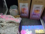 une enseigne lumineuse indiquant « Karaoke Party » à côté de deux cartons portant la mention « Karaoke Party »