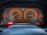 a close up of a dashboard with a speedometer and gauges