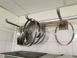 pots and pans hanging from the ceiling in a kitchen