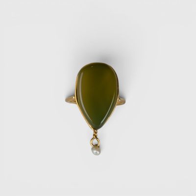 une bague en or sertie d'une pierre verte et d'une perle