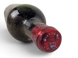 a bottle of wine that is sitting on a white surface