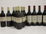 several bottles of wine are lined up in a row on a table
