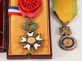 two medals and a medal are in a box on a table