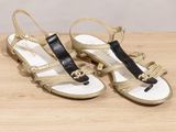 pair of women ' s sandals on a wooden table with a white background