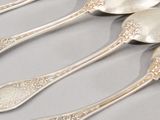 five spoons that are sitting next to each other on a table