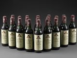 six bottles of wine lined up in a row on a table