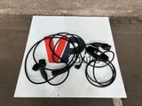 a white sign with black wires and a red v on it