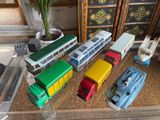a lot of toy cars and buses on the table