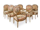 four chairs with a floral upholstered back and arms are arranged in a row