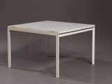 a white table with a marble top on a grey surface