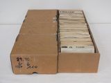 a cardboard box full of old records on a white surface