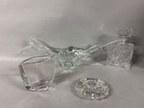a glass bowl and a glass decanter sitting on a table