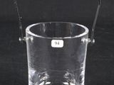 a clear glass with a handle on a black background