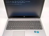 a laptop with a blue screen sitting on a white table