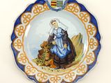 a plate with a picture of a woman and a lion on it