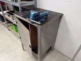 a metal cabinet with a blue vise on top of it