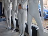 mannequins lined up in a row in front of a window