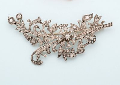 an image of a diamond broochle and a pearl broochle