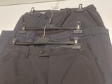 a pair of pants hanging on a hanger on a wall