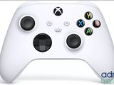 a close up of a white controller on a white surface