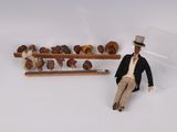 a doll sitting on the ground next to a set of items