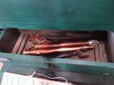 a green box with a couple of pipes inside of it