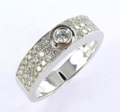 a close up of a diamond ring on a white background