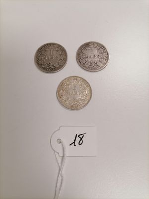 three different types of coins on a white surface with a price tag