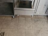 tiled floor in a kitchen with a microwave oven and sink