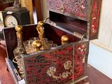 a small wooden box with a clock on top of it