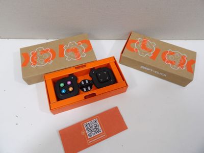 a box with two remote controls in it and a box with a qr code on it