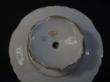 a white plate with a white and red design on it