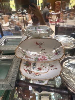 a glass display case with plates and bowls on it