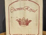 a box of wine sitting on a table with a glass of wine